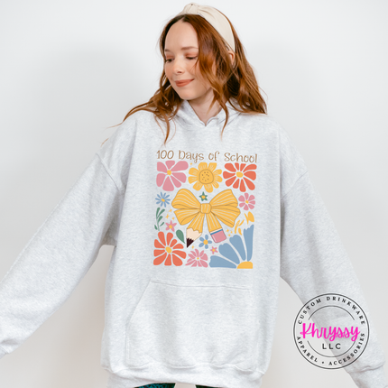 Vibrant floral bow 100 days hoodie on ash Gildan with warm pink and gold flower graphic