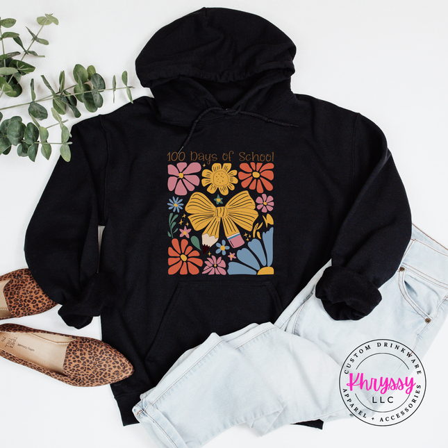 Bold 100 days floral celebration hoodie on black Gildan with pink gold and blue botanical bow print