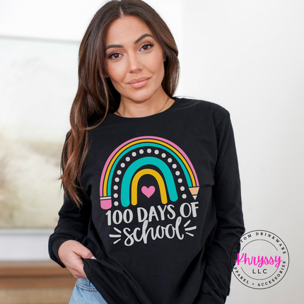 Woman wearing a black 100 Days Of School rainbow graphic tee outdoors.