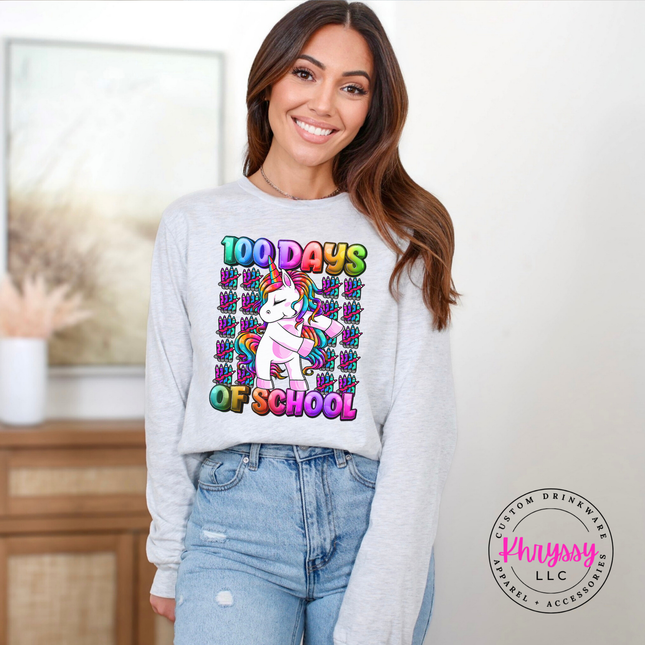 Woman wearing an ash colored 100 Days Of School unicorn rainbow tee.