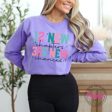Violet long sleeve tee showing colorful New Year lettering and black script.
