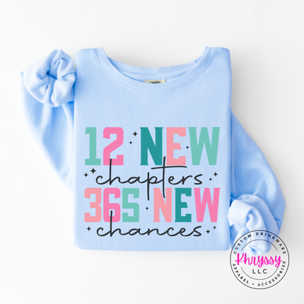 Hydrangea long sleeve tee showing colorful New Year lettering and black script.