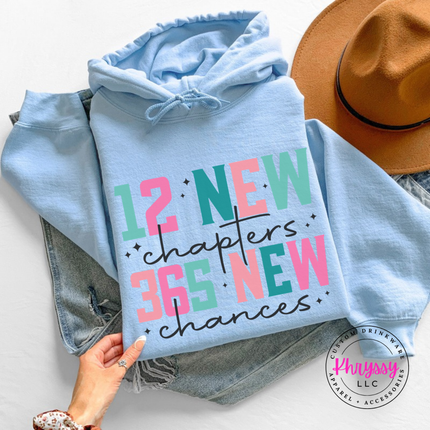 Light Blue hoodie showing colorful New Year lettering and black script.