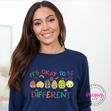 It’s okay to be different multicolor educator long sleeve on navy Bella Canvas with bright classroom graphic