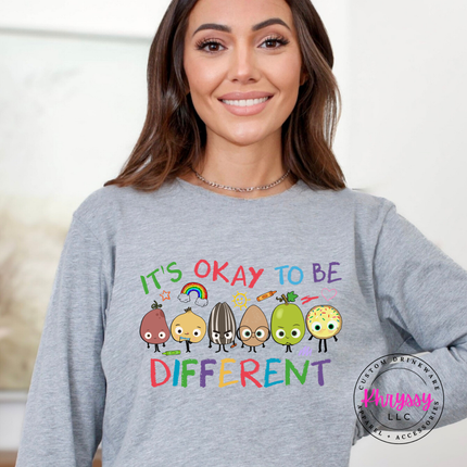 Vibrant inclusion teacher long sleeve on Heather Dark Gray Bella Canvas with colorful crayon characters and rainbow print