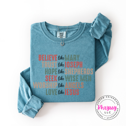Flat lay of the Believe Like Mary Christmas long sleeve tee in Ice Blue.