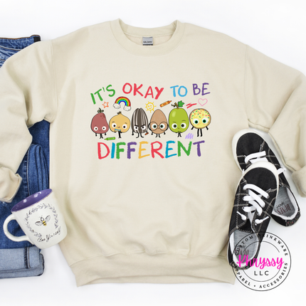 Vibrant inclusion teacher crewneck sweatshirt on sand Gildan with colorful crayon characters and rainbow print