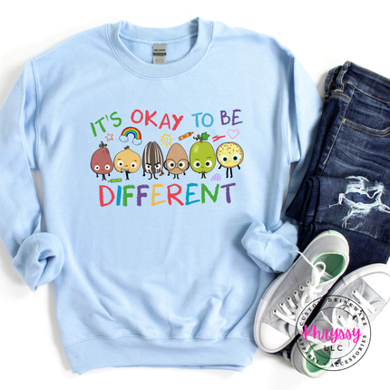 Cheerful colorful inclusion statement crewneck on light blue Gildan with bright cheerful character detail