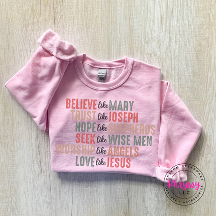 Close up of the Believe Like Mary art on a Light Blue crewneck sweatshirt.