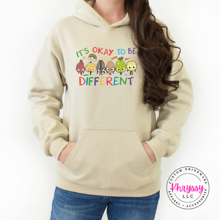 It’s okay to be different multicolor educator hoodie on sand Gildan with cheerful rainbow character graphic