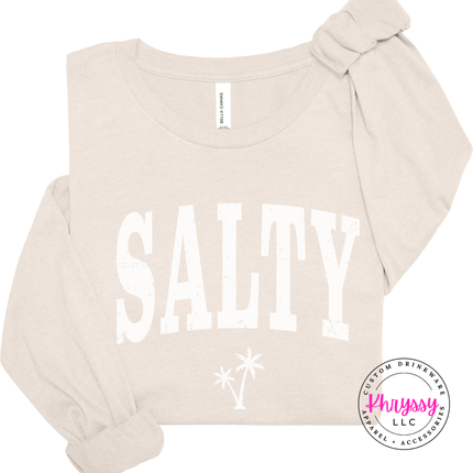 Natural long sleeve tee showing a distressed black SALTY coastal graphic.