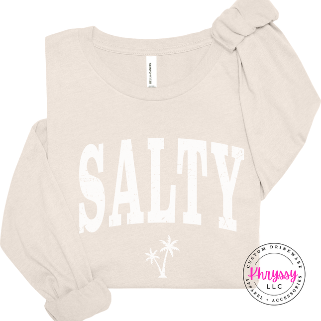 Natural long sleeve tee showing a distressed black SALTY coastal graphic.