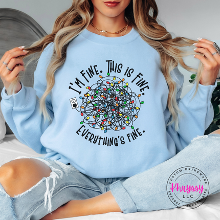 Close up of the Everything's Fine tangled lights on a Light Blue crewneck sweatshirt.