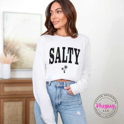 White long sleeve tee displaying a black distressed SALTY beach graphic.