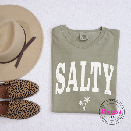 Khaki garment-dyed tee showing a distressed black SALTY coastal graphic.