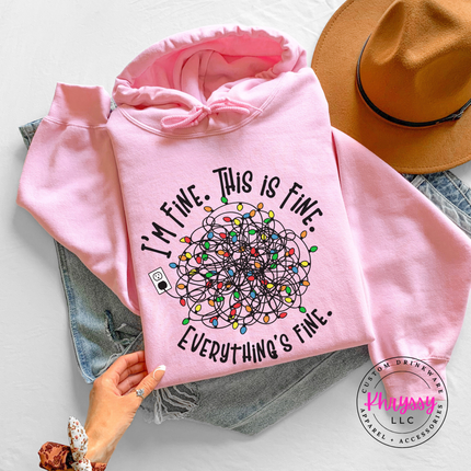 Close up of the Everything's Fine tangled lights on a Light Pink hoodie.