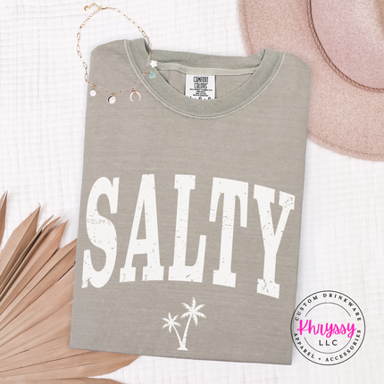 Sandstone garment-dyed tee with a black SALTY varsity and palm tree design.