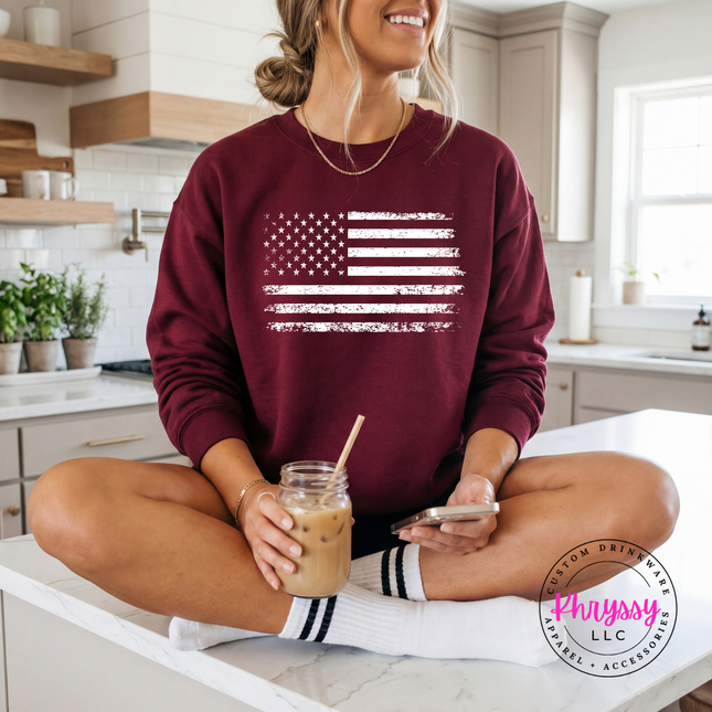 Maroon crewneck sweatshirt showing a distressed white American flag design.