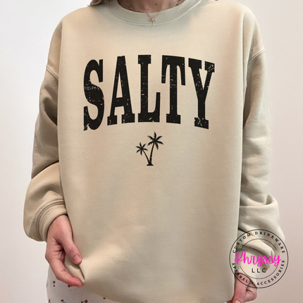 Sand crewneck sweatshirt with a black SALTY varsity and palm tree design.