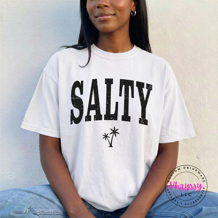 White garment-dyed tee displaying a black distressed SALTY beach graphic.