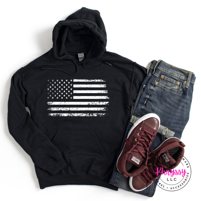 Black pullover hoodie with a white distressed American flag graphic on the chest.