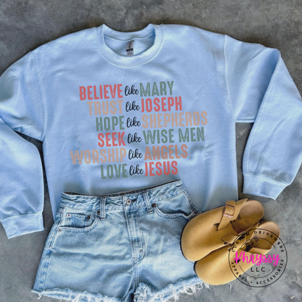 Close up of the Believe Like Mary art on a Light Blue crewneck sweatshirt.