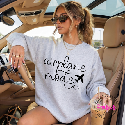 Ash crewneck sweatshirt showing a black airplane mode script with a tiny plane