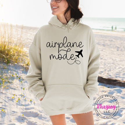 Sand pullover hoodie displaying a black airplane mode script and plane graphic.
