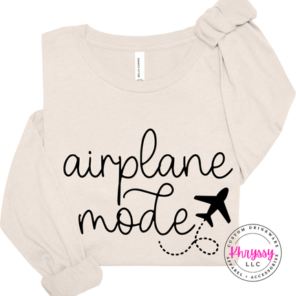Natural long sleeve tee showing a black airplane mode script with a tiny plane.