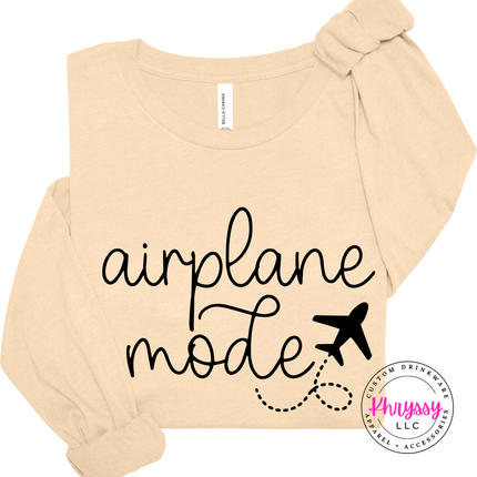 Soft Cream long sleeve tee with a black airplane mode travel graphic on the chest.