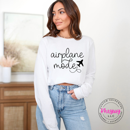 White long sleeve tee displaying a black airplane mode script and plane graphic.