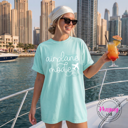 Chalky Mint garment-dyed tee featuring a black airplane mode travel script design.