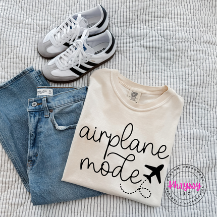 Ivory garment-dyed tee showing a black airplane mode script with a tiny plane.