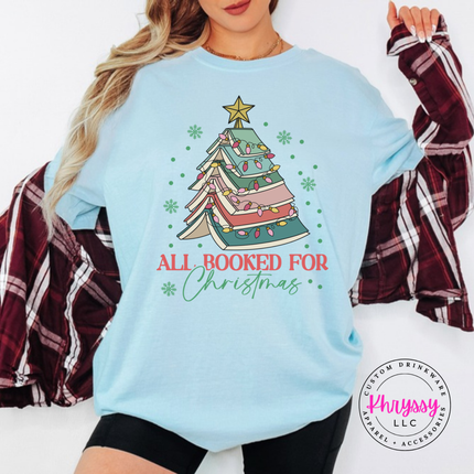Chambray tee showing a tree of open books wrapped in Christmas lights.