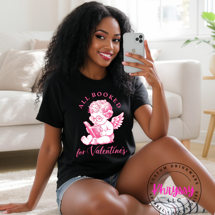 Woman wearing a black t-shirt with a graphic design, sitting on the floor in a living room.