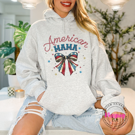 Ash pullover hoodie with a patriotic American Mama flag-bow graphic on the chest.