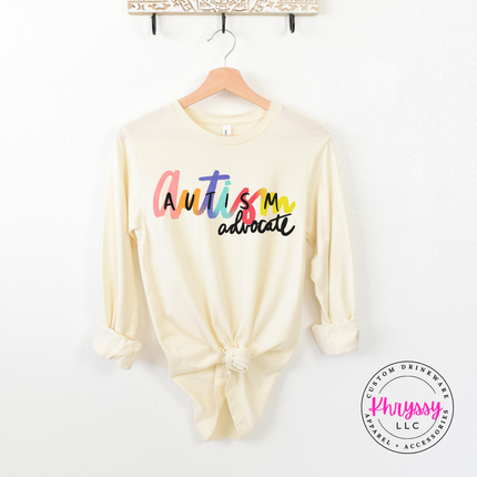 Lightweight autism advocate tee in Natural with colorful rainbow script.