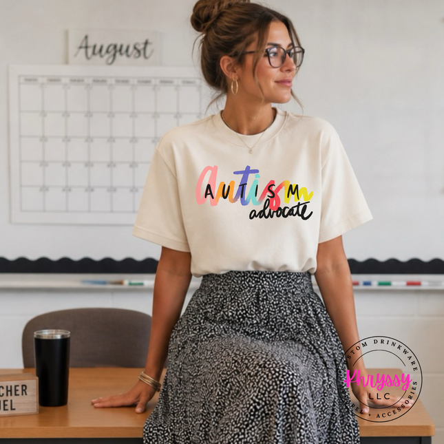 Colorful autism advocate graphic shown on an Ivory colored tee.