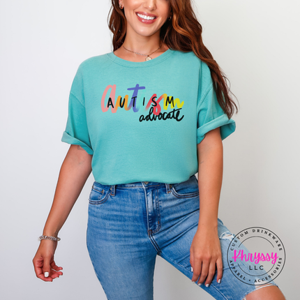 Close-up of rainbow brush-script lettering on a Seafoam colored tee.