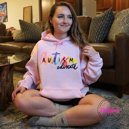 Autism advocate hoodie in Light Pink, layered for a chilly day.