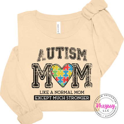 Soft Cream colored long sleeve displaying a colorful autism awareness design.
