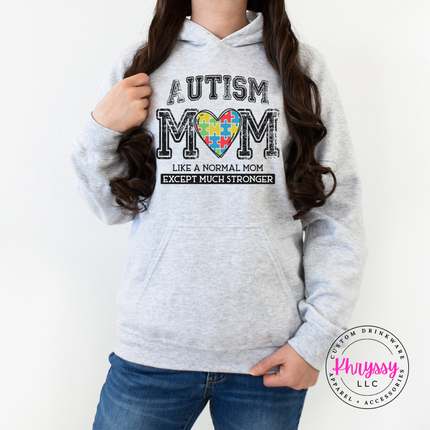 Ash pullover hoodie with a colorful puzzle-piece heart autism mom graphic.