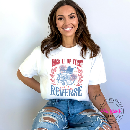 Woman wearing a white t-shirt with a graphic design and text, sitting against a light gray background.