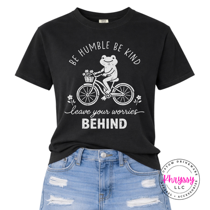 Black tee with a white frog riding a bike and be humble be kind text
