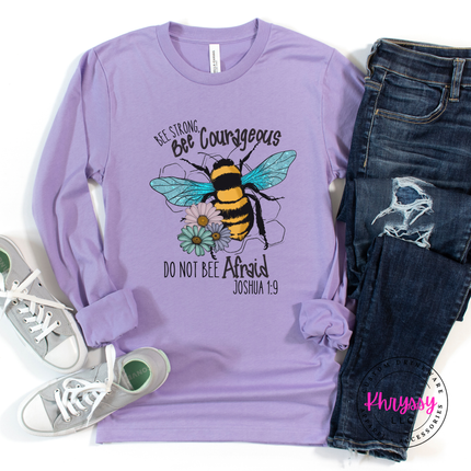 Purple long-sleeve shirt with bee graphic and text, paired with jeans and sneakers on a white background.