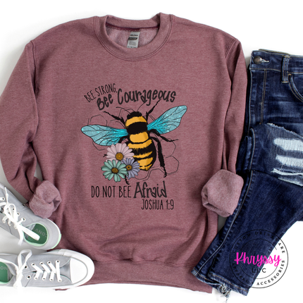 Maroon sweatshirt with bee graphic and text, paired with jeans and sneakers on a white background.