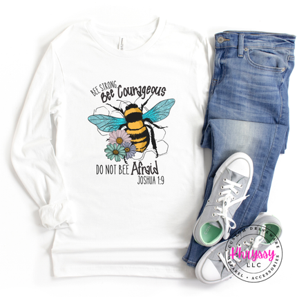 White long-sleeve shirt with bee graphic and text, paired with jeans and sneakers on a white background.