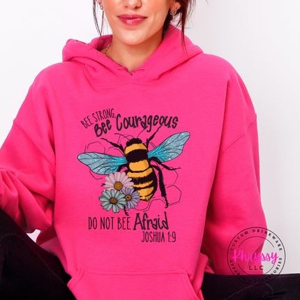 Person wearing a pink hoodie with a bee design and text