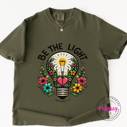 Sage tee showing a blooming lightbulb and hand-lettered Matthew verse