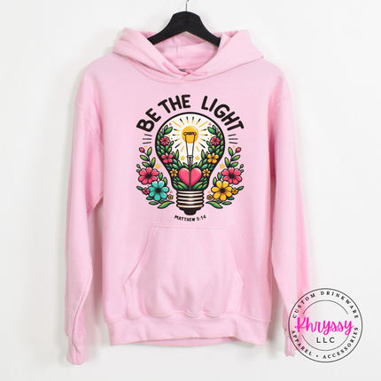 Light Pink hoodie showing a blooming lightbulb and hand-lettered Matthew verse